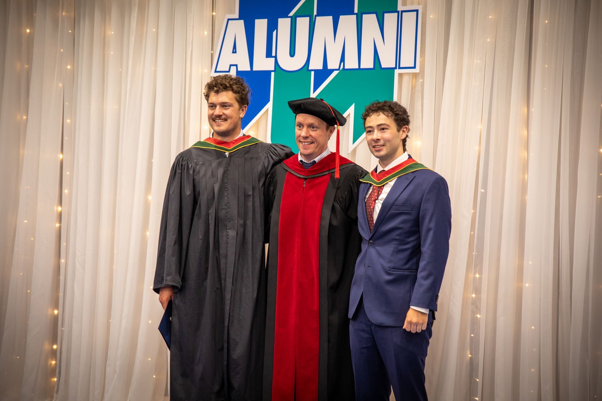 Two Nipissing University graduates with faculty member