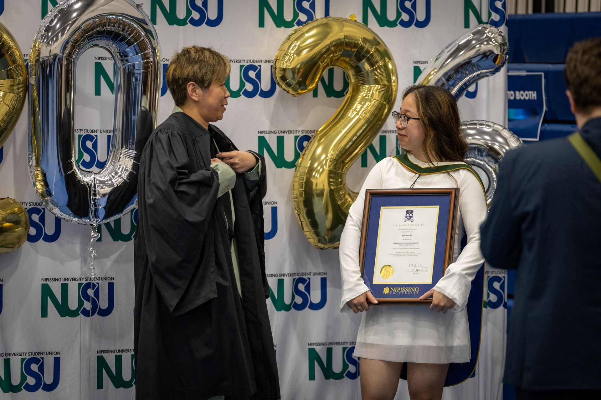 Nipissing University graduate with their family