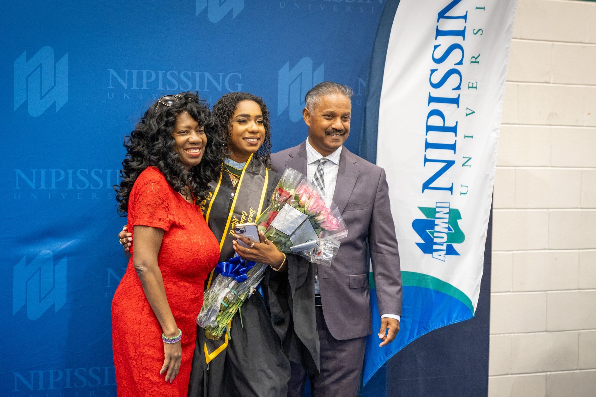 Nipissing University graduate with their family