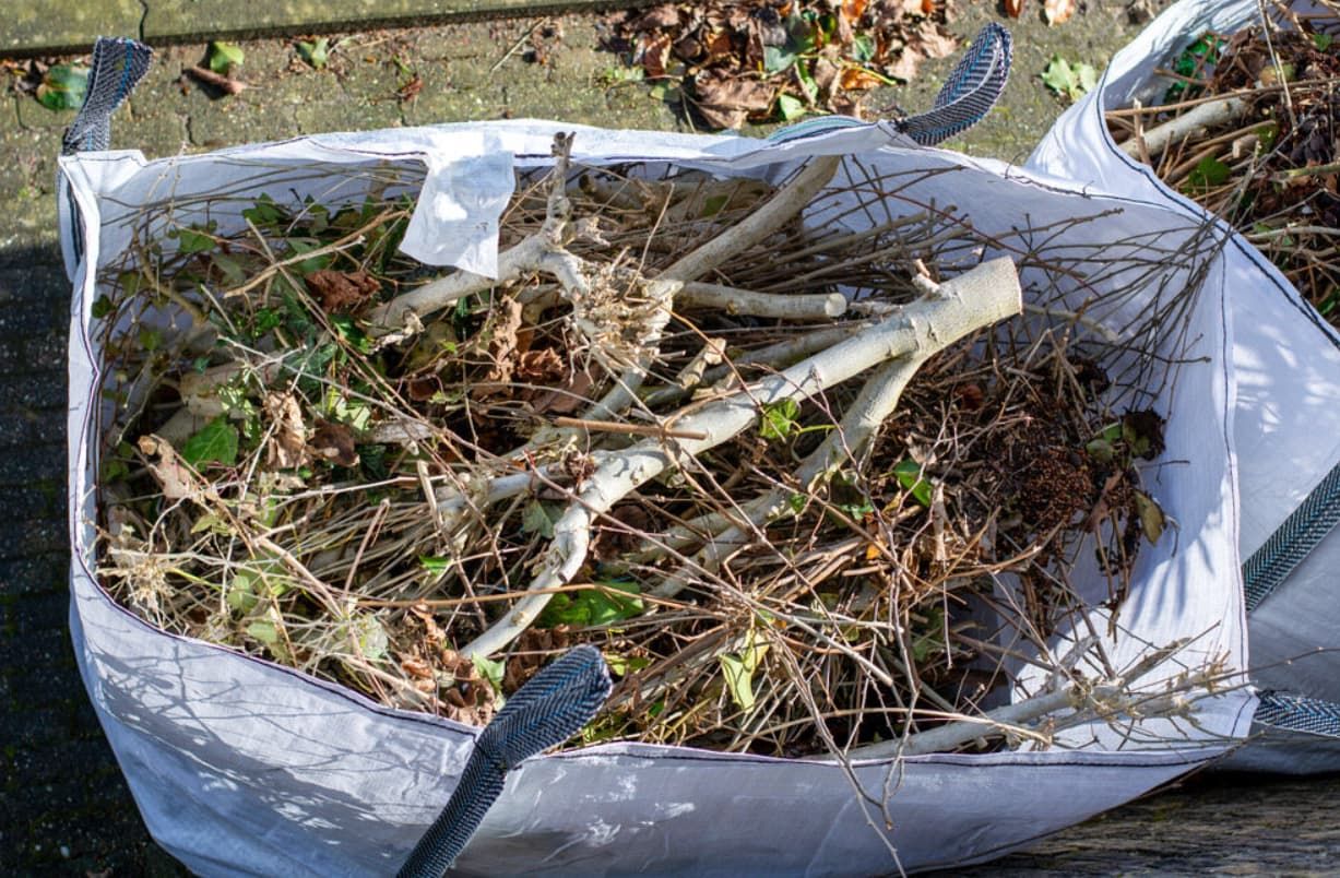 A Bag Filled With Branches And Leaves Is Sitting On A Table — Mackay Bags in Ooralea, QLD