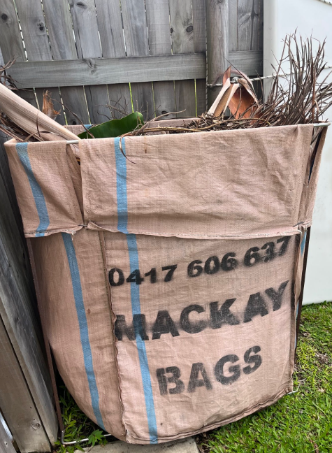 A Blue Bin And Brown Garden Bag On Grass— Mackay Bags in East Mackay, QLD