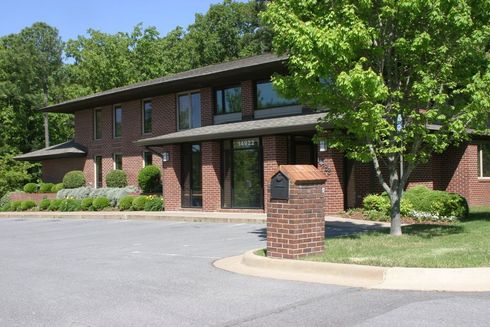 A large brick building with a mailbox in front of it