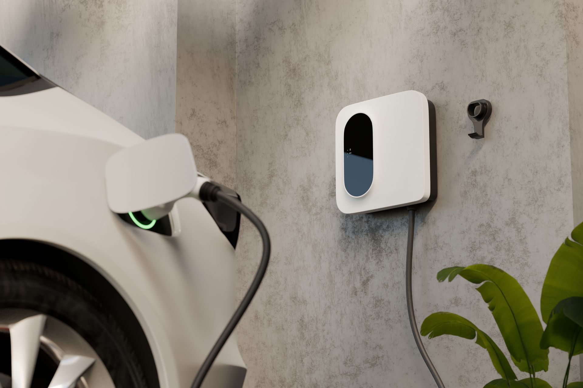 White electric car charging, plugged into a wall-mounted charging station with a hanging cable and a small green light.