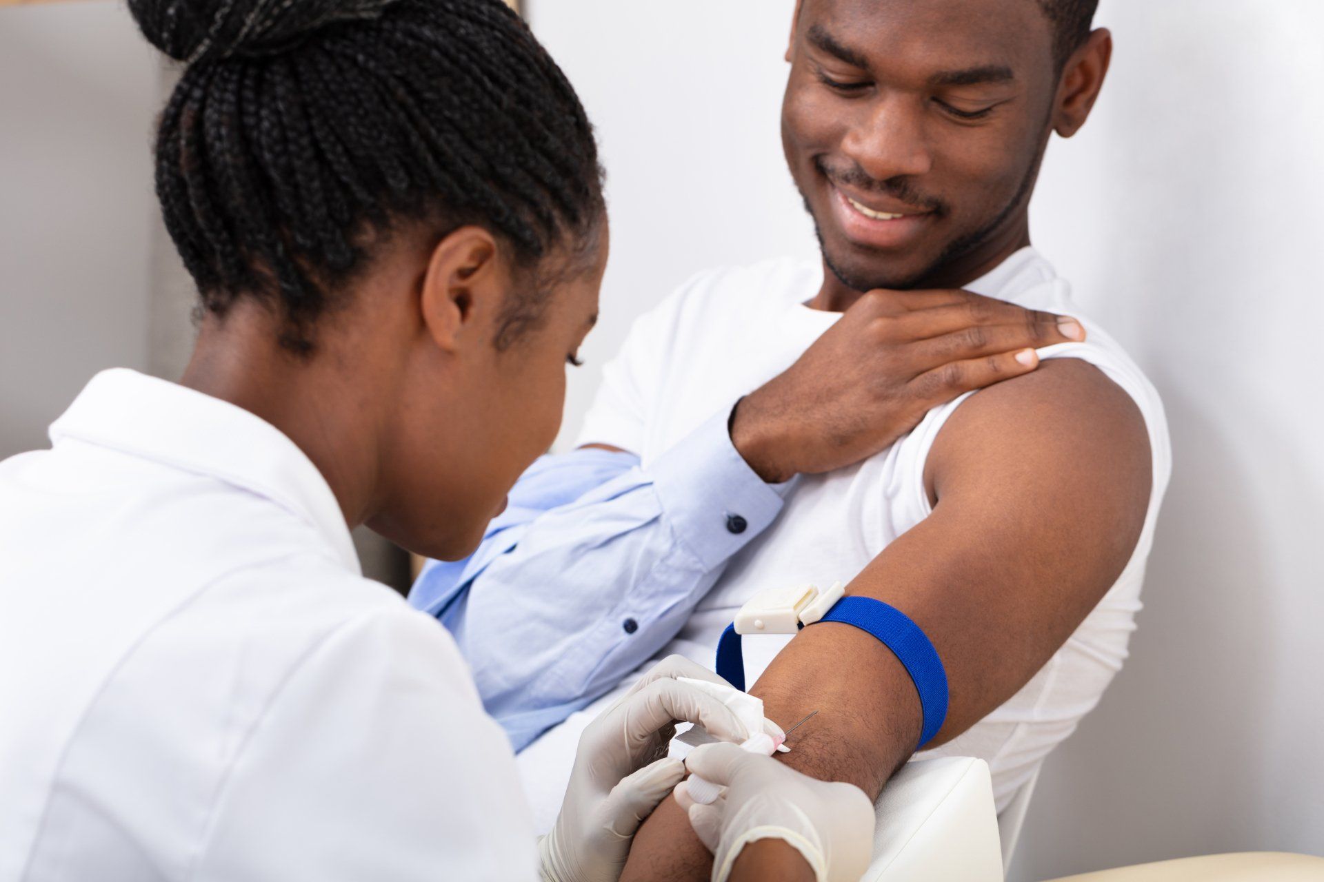 Medical assistant helping patient