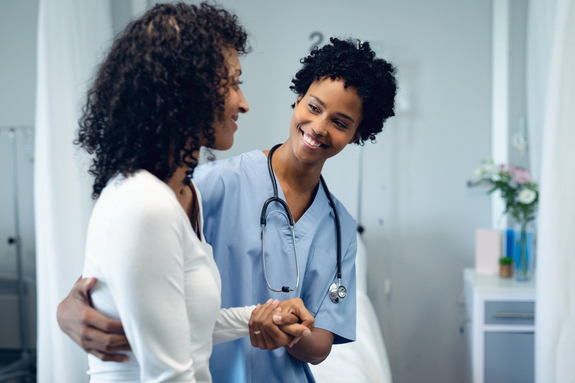 Medical assistant helping patient