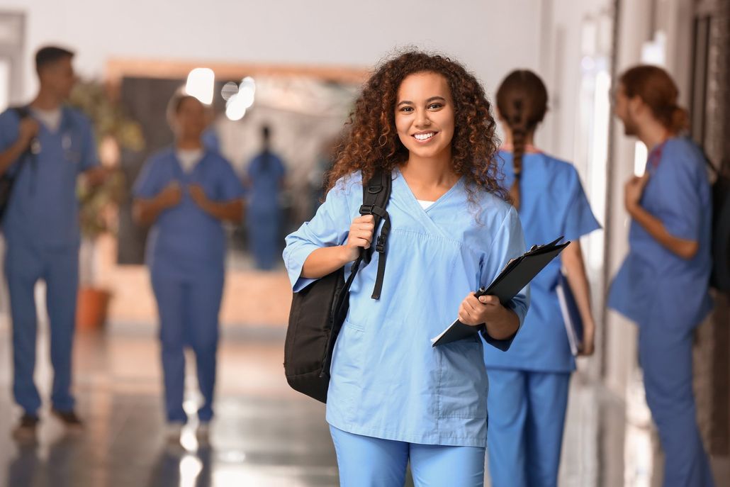 Student with hospital garb posing for the camera
