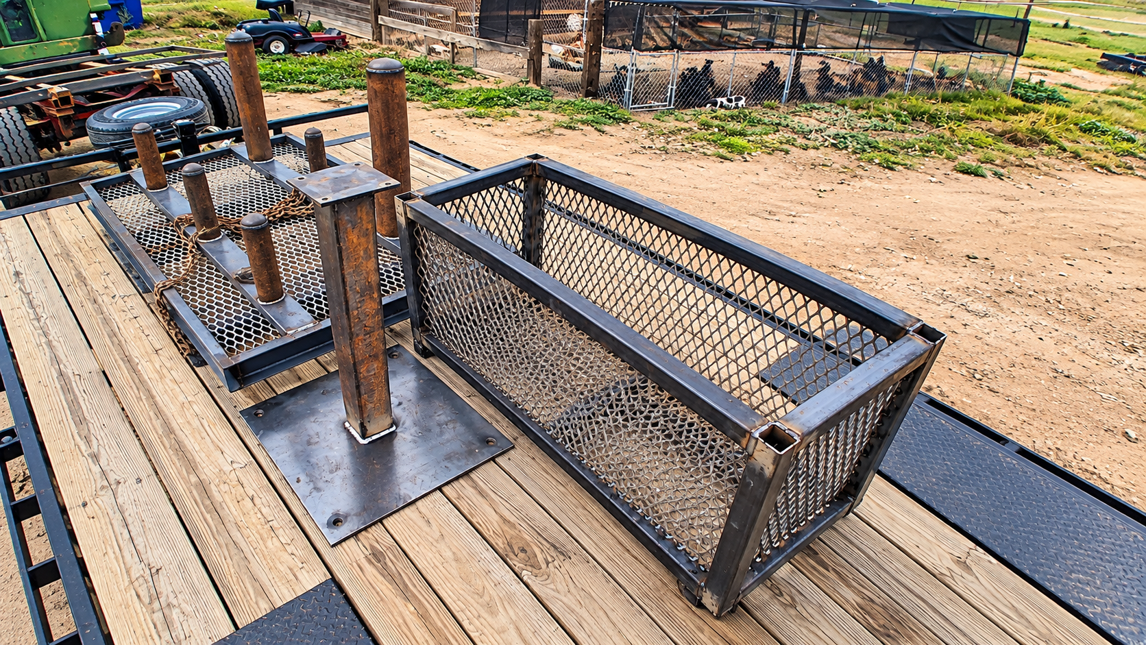 Outdoor metal mesh bench and railing on a wooden deck in a yard or work area.