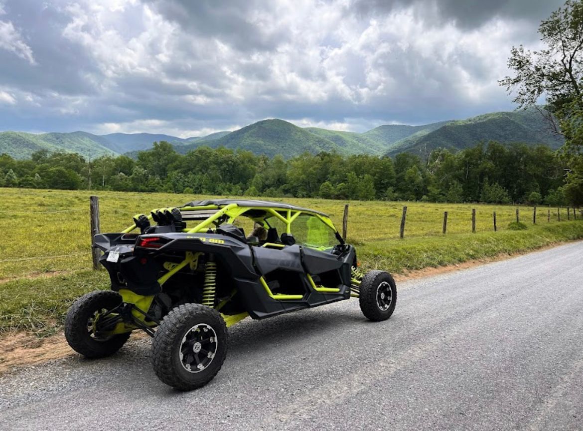 A yellow and black atv is parked on the side of a road.