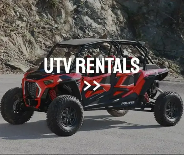 A red atv is parked on the side of the road.