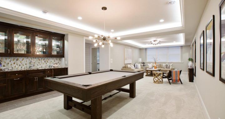 There is a pool table in the middle of the room.