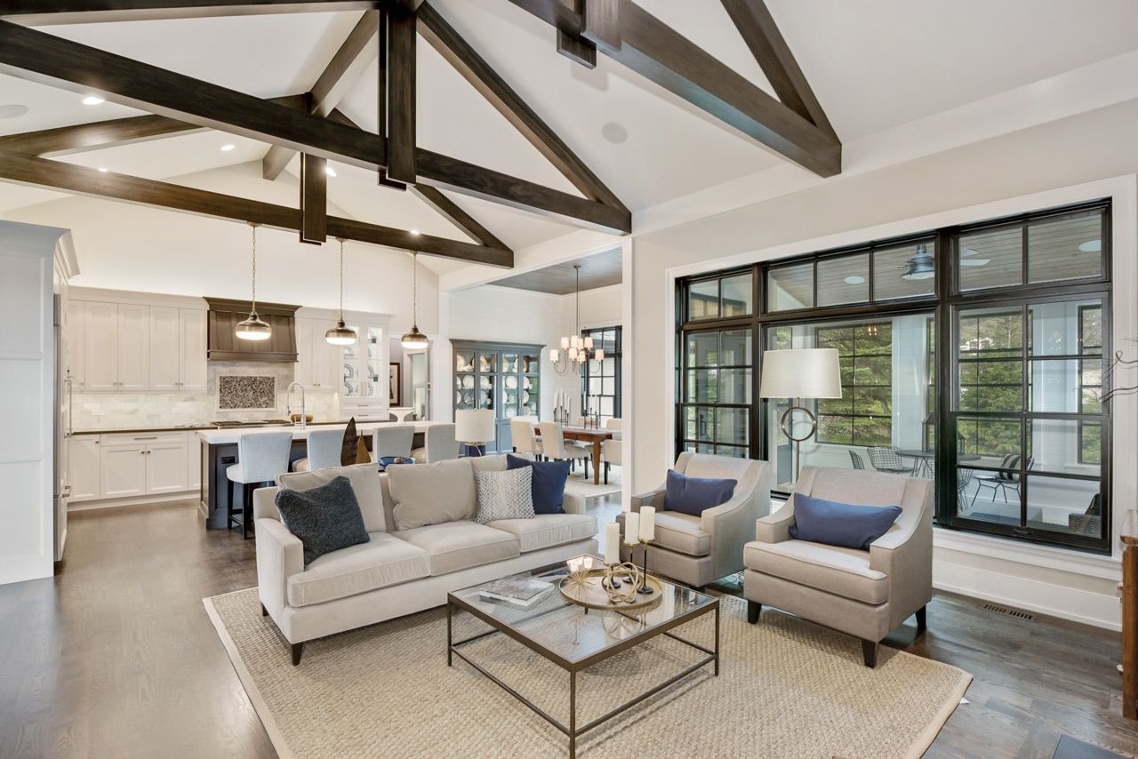 A living room with a couch , chairs , and a coffee table.