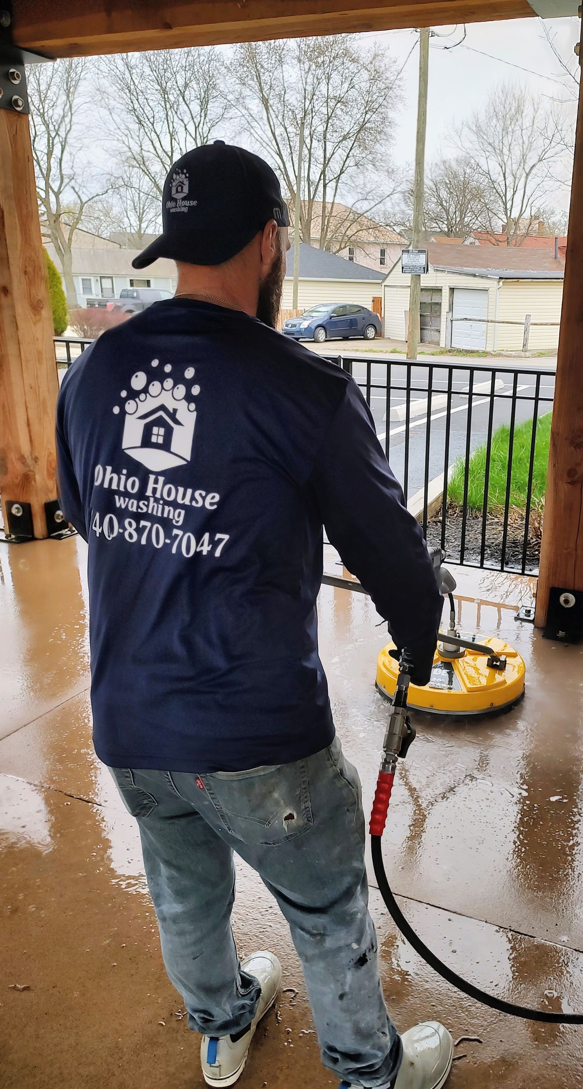A blue fan is sitting in a bathroom next to a toilet.
