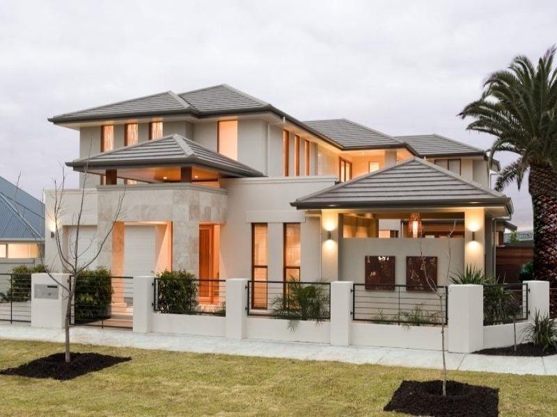Modern two-story house with cream exterior, multiple roofs, and palm tree.