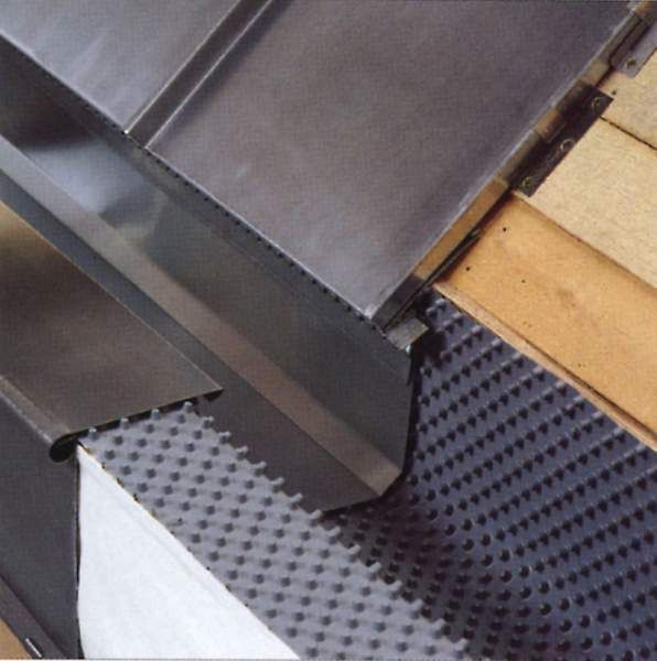 Metal gutter system with a perforated edge and wooden support.