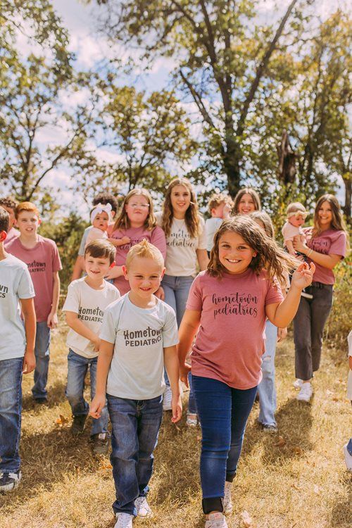 Group of children walking outdoors in a sunny park