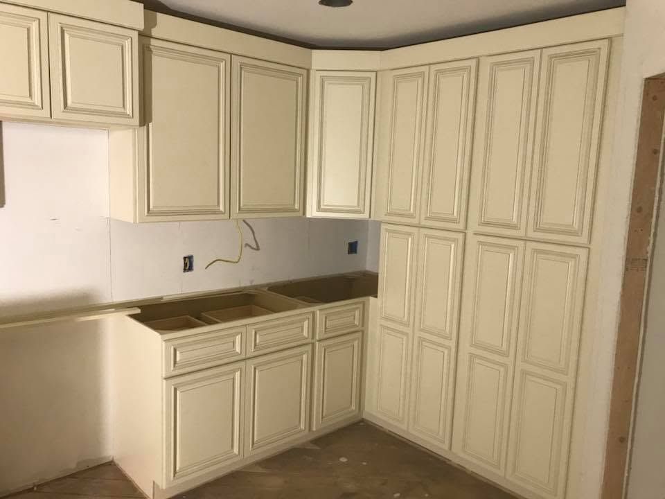 Built-in beige cabinet doors with black trim in a modern hallway, beside a window and marble floor
