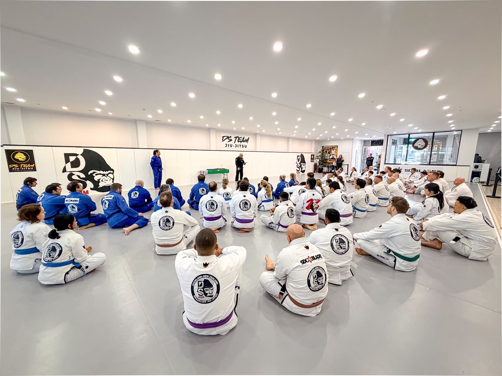 Instructor coaching student on the mat
