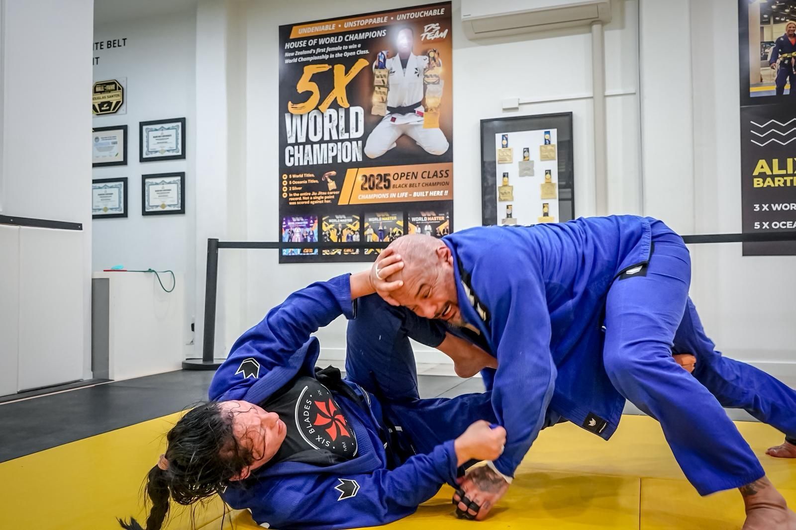 Instructor coaching student on the mat