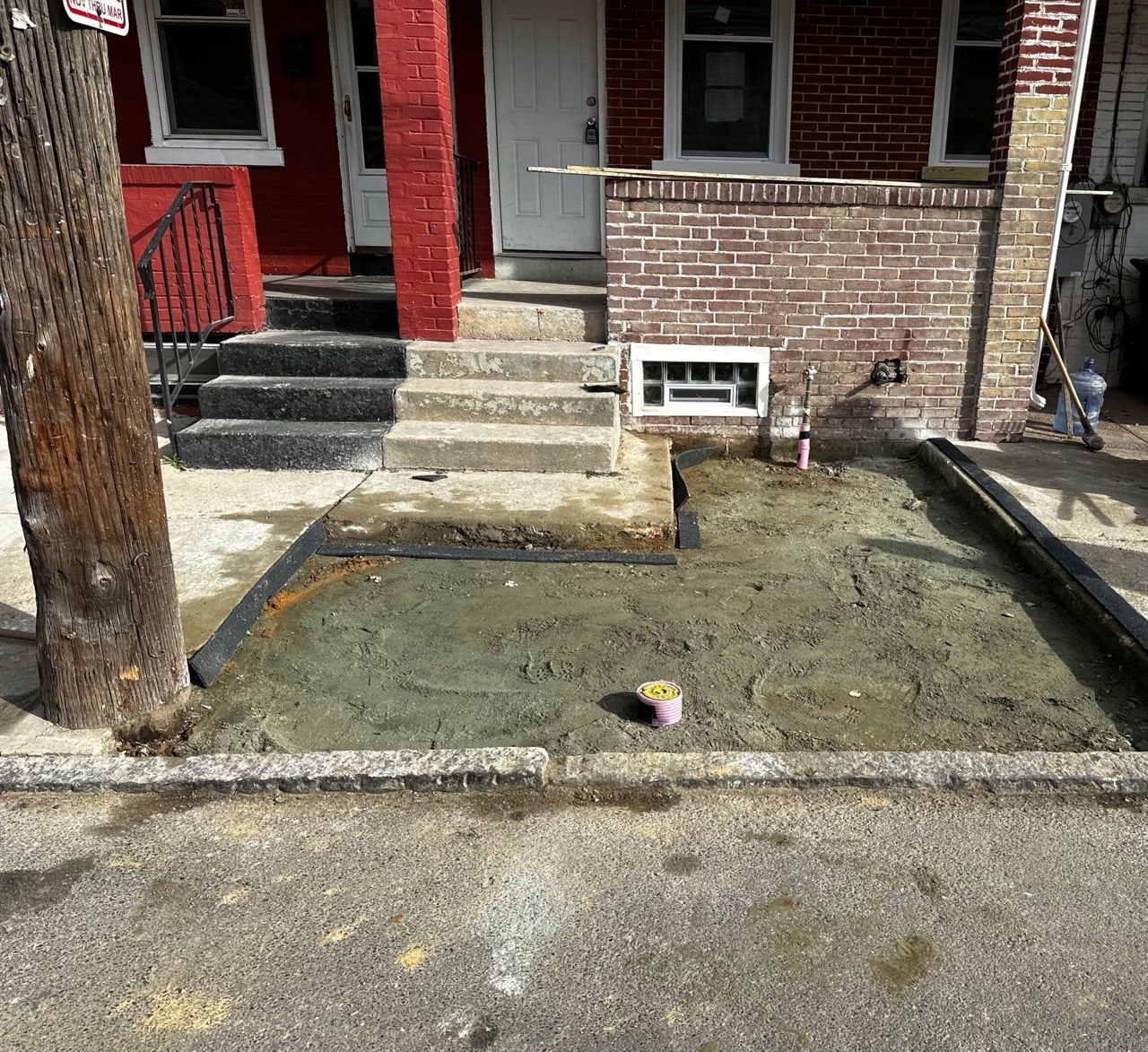 a brick house with a concrete area in front of it
