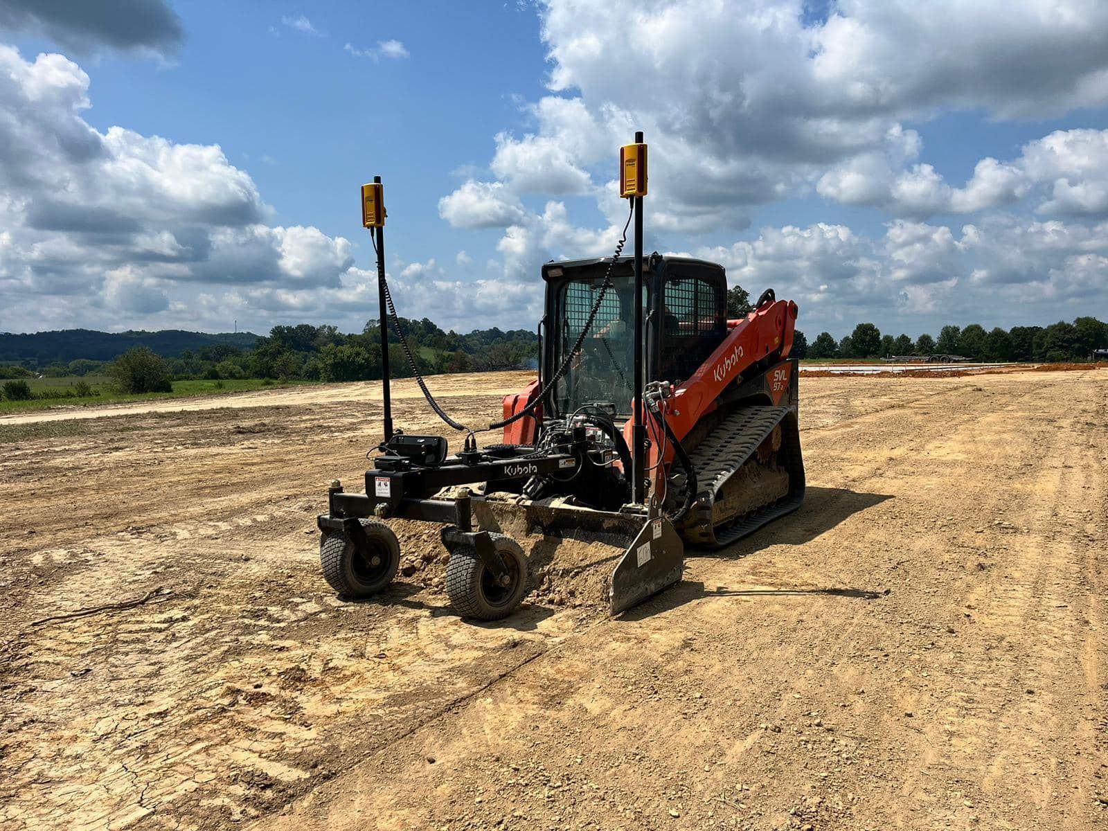 A bulldozer is sitting in the middle of a dirt field.