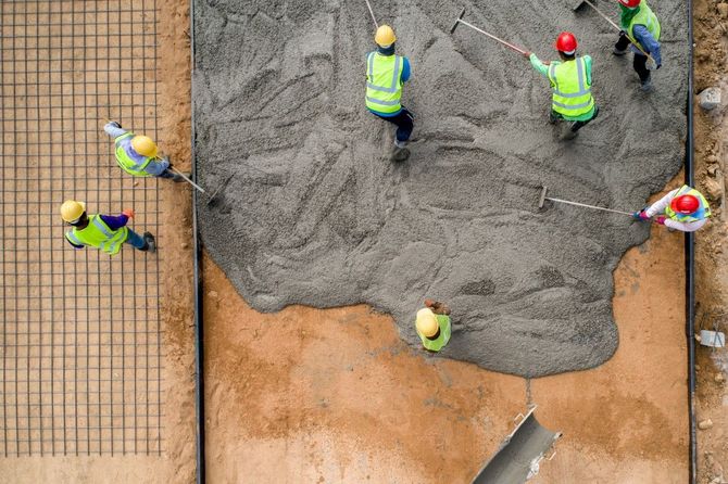A picture of a group of Concrete Contractors in Des Moines, WA wearing yellow vests.