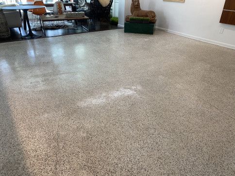 A living room with a statue of a lion on the floor.