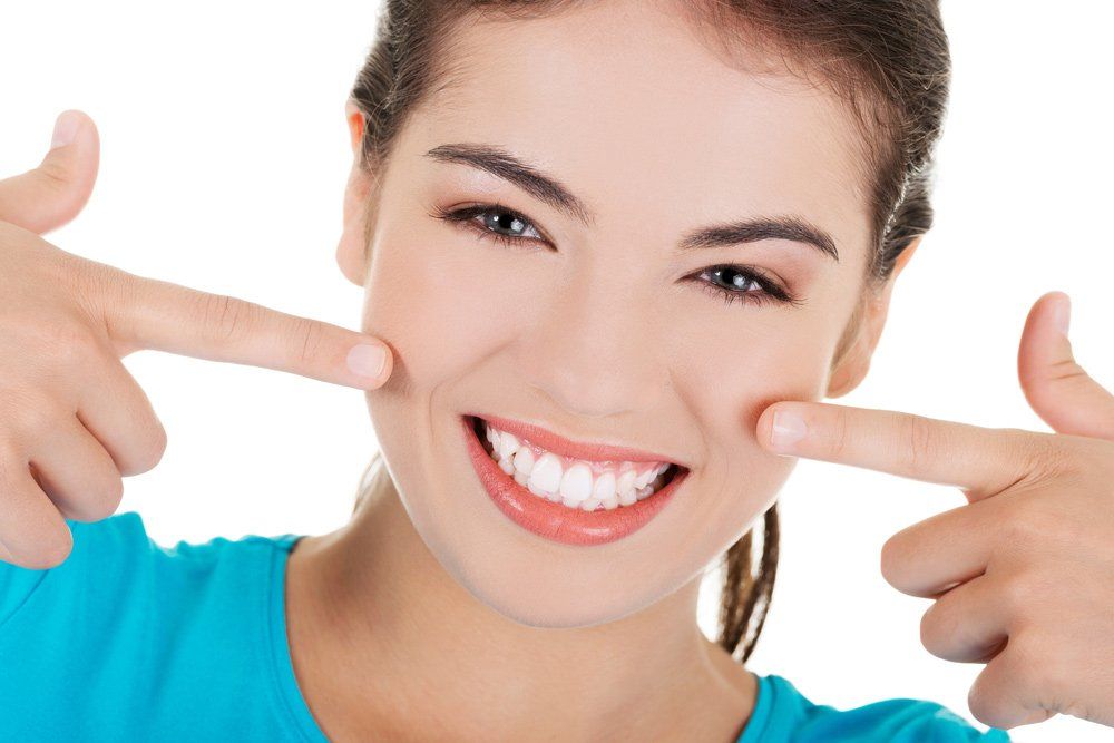 Portrait of Woman Showing her Teeth — Teeth Whitening in Newcastle, NSW