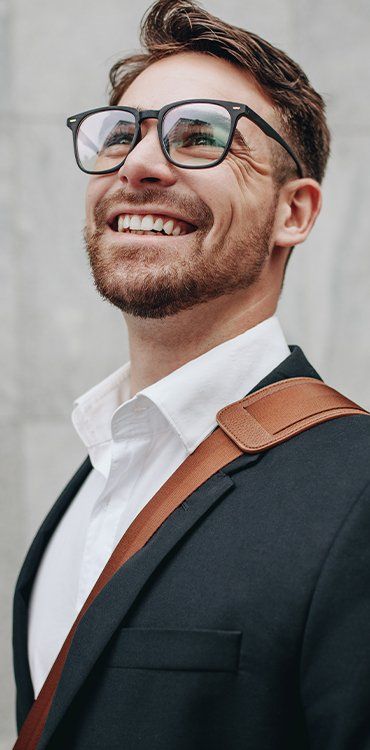 Man With Eyeglasses Looking Up & Smiling — Facial Rejuvenation in Newcastle, NSW