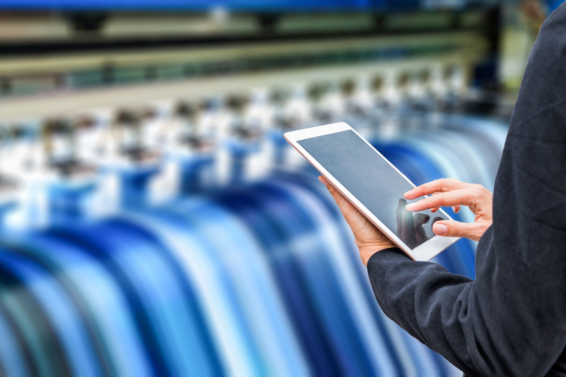 A Person Is Holding A Tablet In Front Of A Printing Machine — Elmira, NY — Rainbow Lettering A Person Is Holding A Tablet In Front Of A Printing Machine — Elmira, NY — Rainbow Lettering