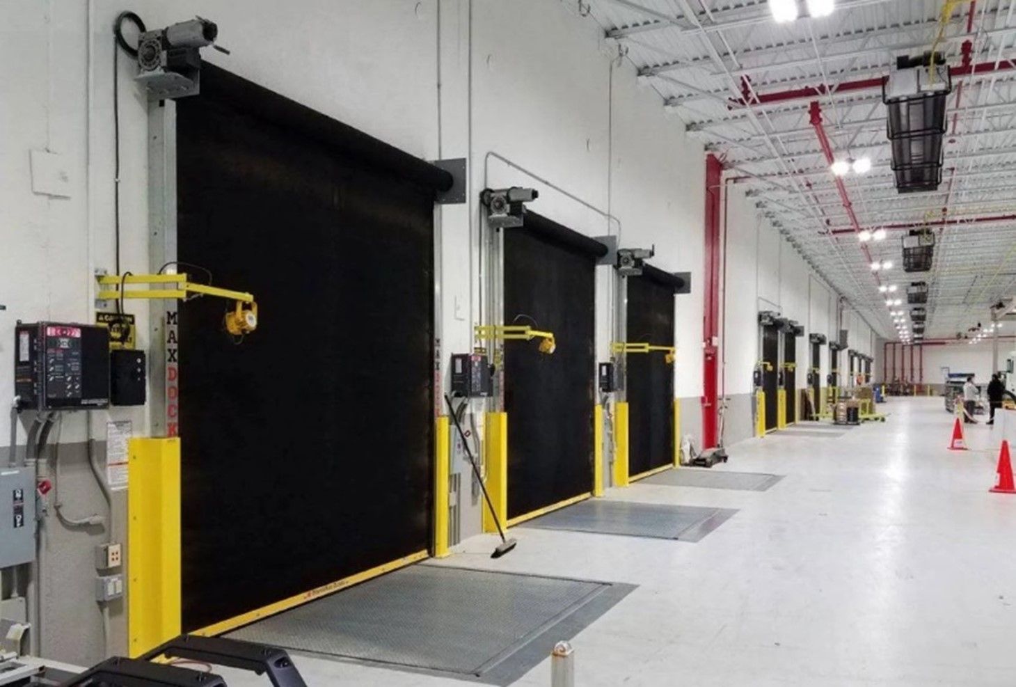 A warehouse with a lot of doors and cones