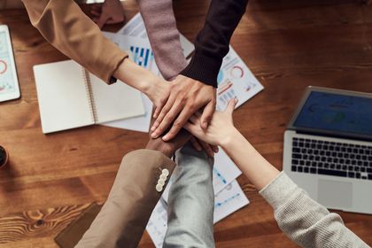Two women are sitting at a counter in a hair salon.