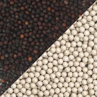 Close-up of black and white peppercorns divided by a diagonal line