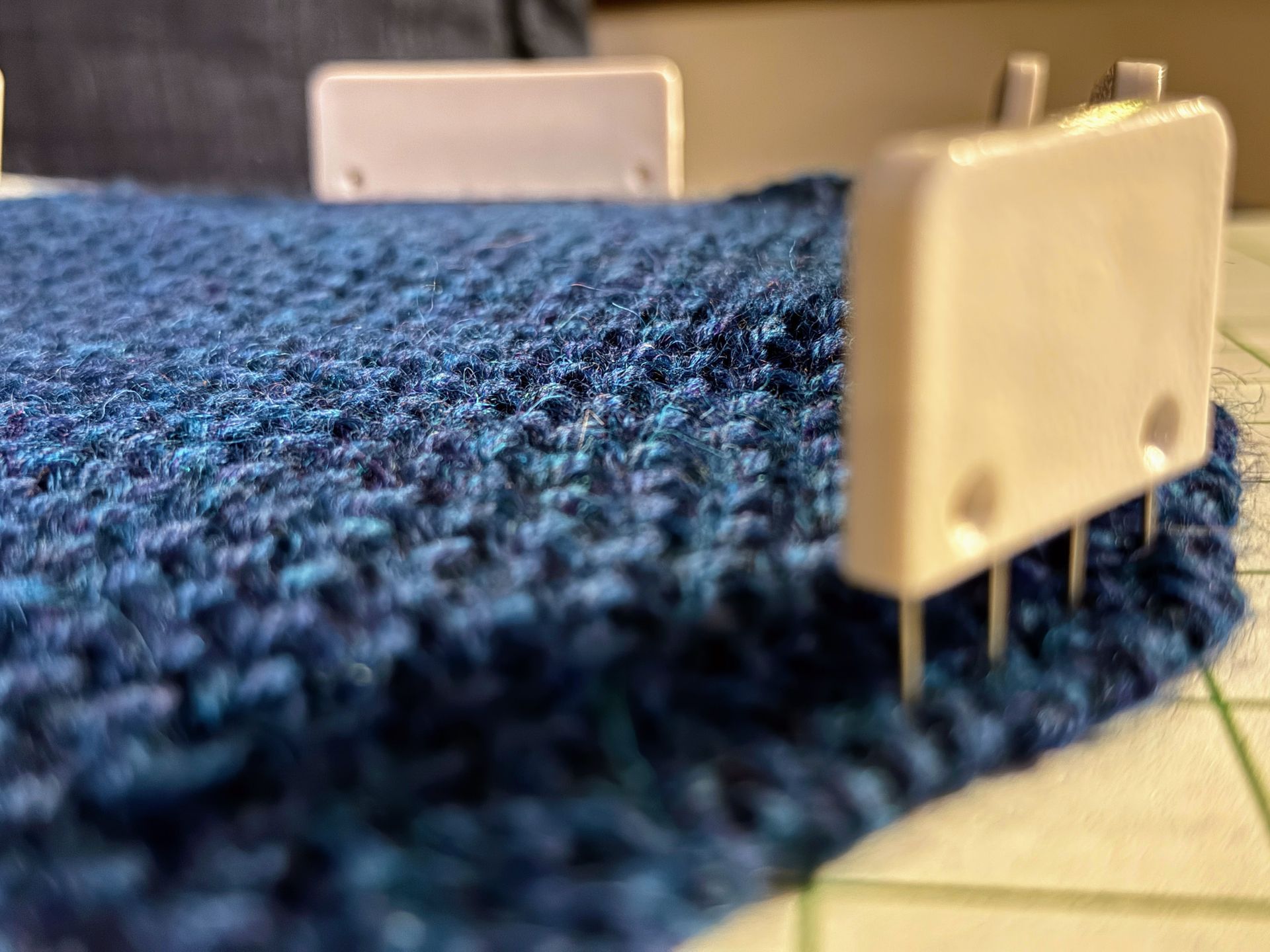 knitted cowl on blocking matt