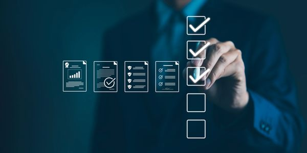 Businessperson checking digital checklist icons on a blue background