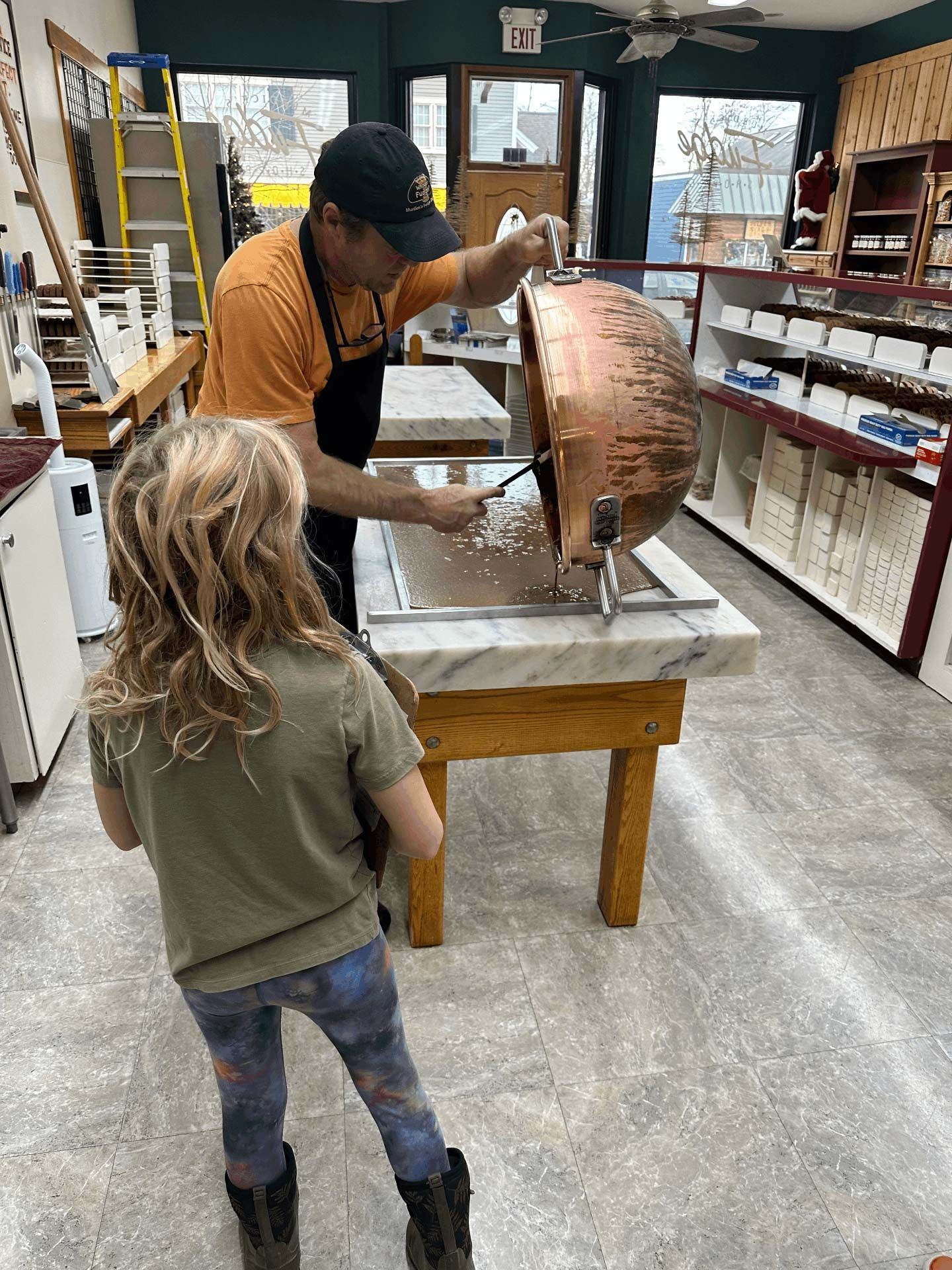 montessori child observing candy making in shop setting