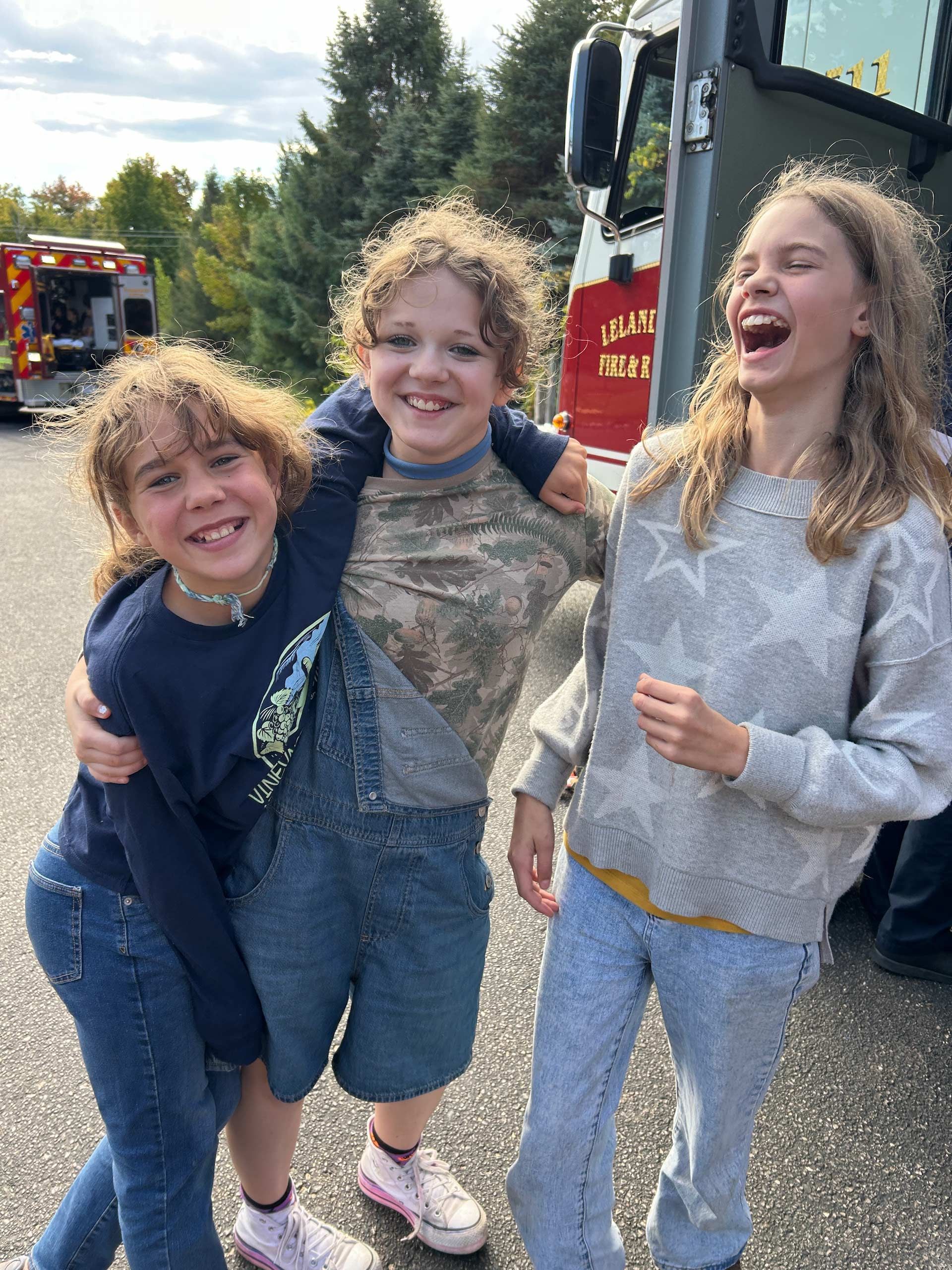 montessori children smiling near fire truck at community event