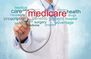 A doctor is holding a stethoscope and pointing at the word medicare.