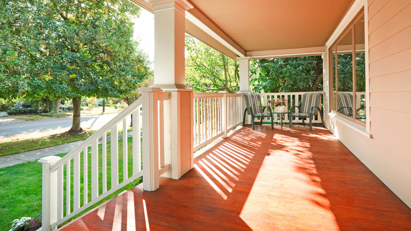 Covered front porch with white railings and red floor installed in Chicago
