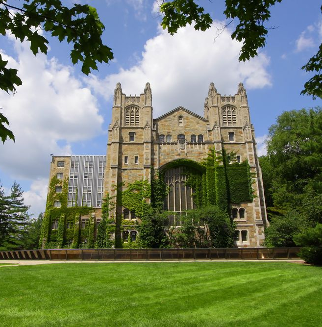 Gothic architecture building, University of Michigan, ivy covered, green lawn, blue sky.
