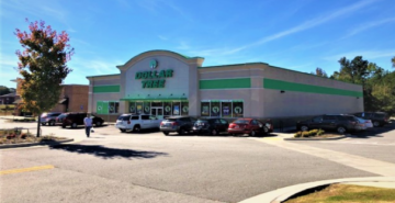 Exterior of a Dollar General store with parked cars on a sunny day