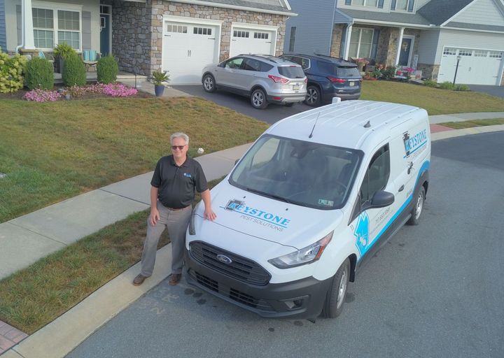 Rob of keystone pest solutions LLC outside of his service van