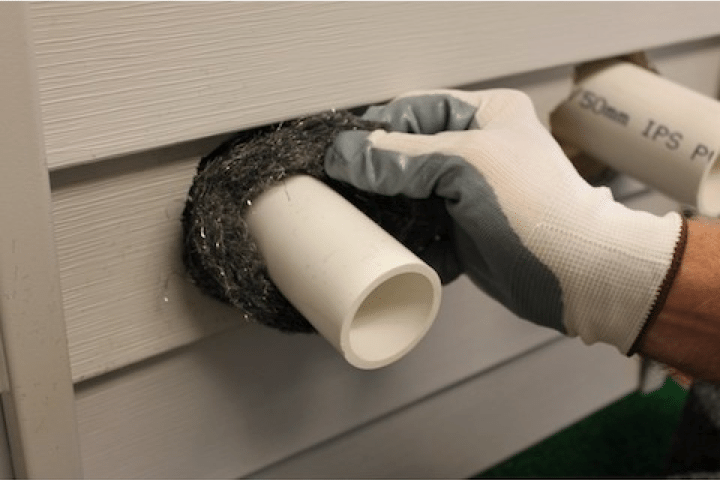 A person wearing gloves blocking mouse entry point.