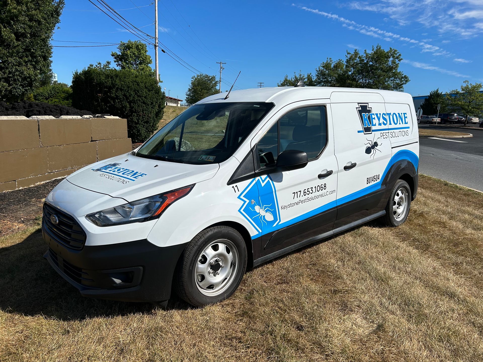 a white keystone pest solutions LLC van is parked on the side of the road in Columbia PA