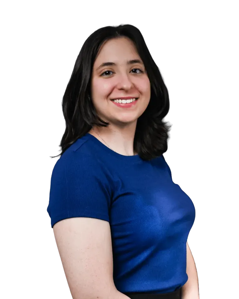 Woman in a blue shirt smiling against a white background