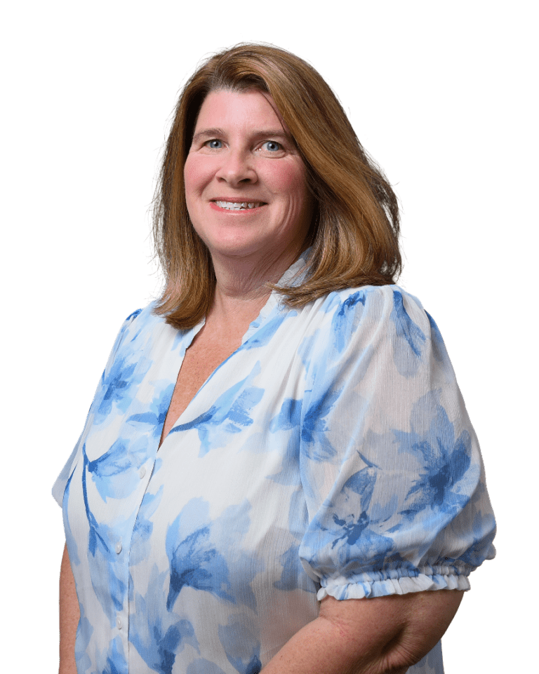 Smiling woman in a blue-and-white patterned blouse on a white background