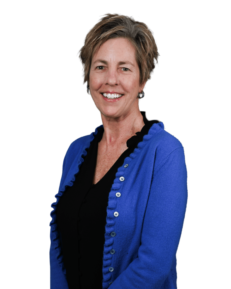 Maren in a blue cardigan over a black top, standing against a white background