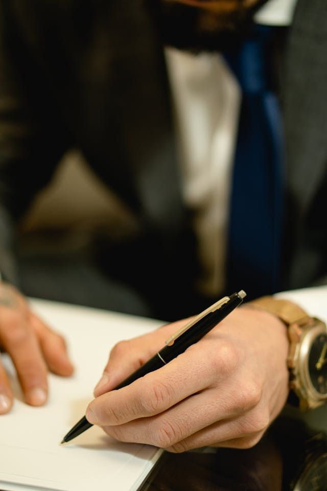 A person handling legal documents and authorizations after a loved one's death