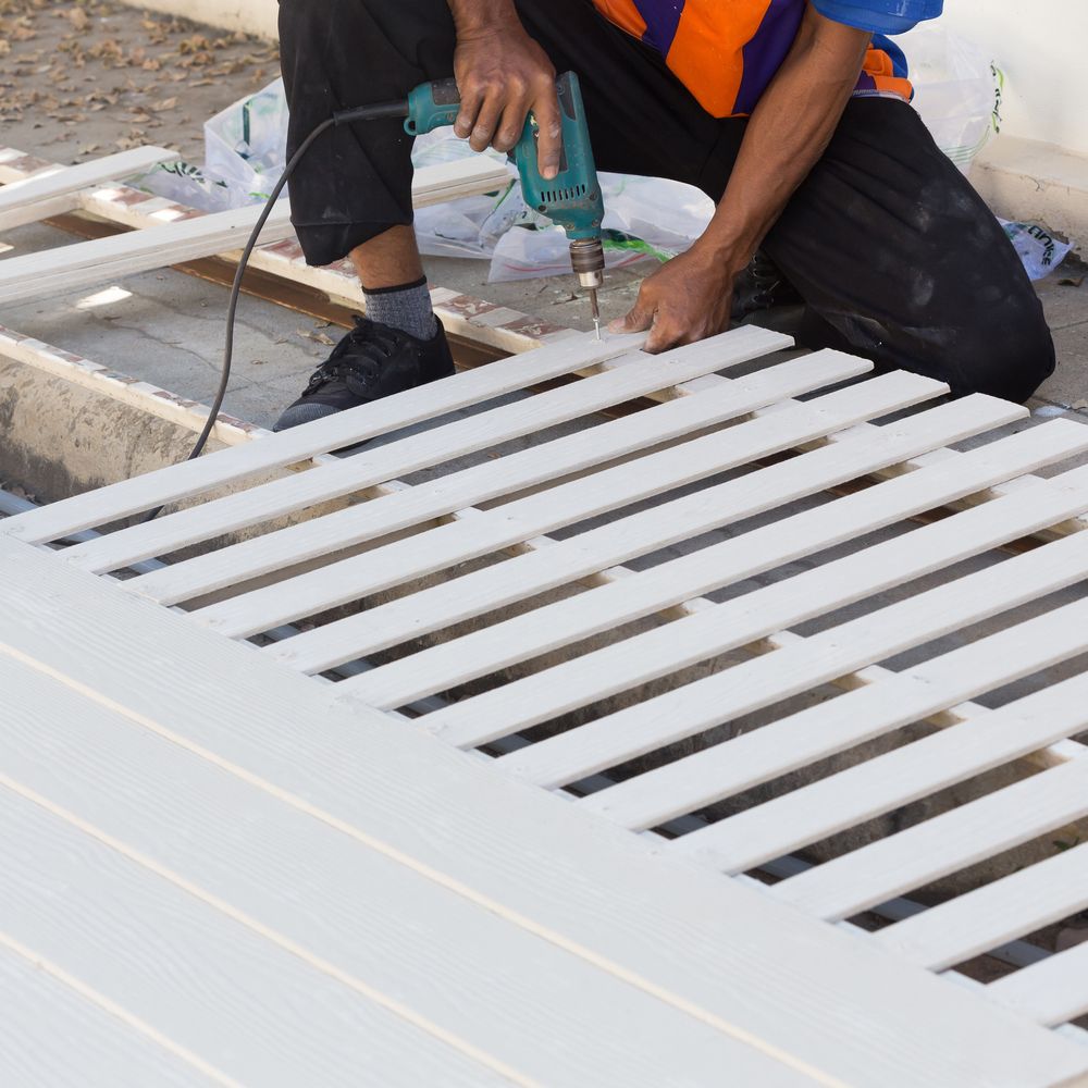 Worker Drilling a White Fence Outdoors — A Plus Project Maintenance in Wodonga, VIC