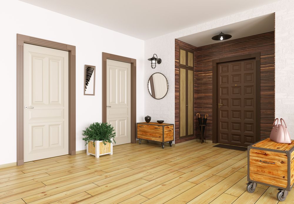 Bright hallway with two white doors, wooden floor, plant, bench, mirror, and a large brown front door. — A Plus Project Maintenance in Wodonga, VIC