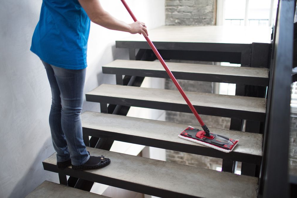Person Mopping Gray Stairs with A Red Mop in A Stairwell — A Plus Project Maintenance in Wodonga, VIC